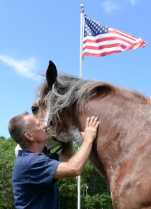 veteran and gruffy man and flag